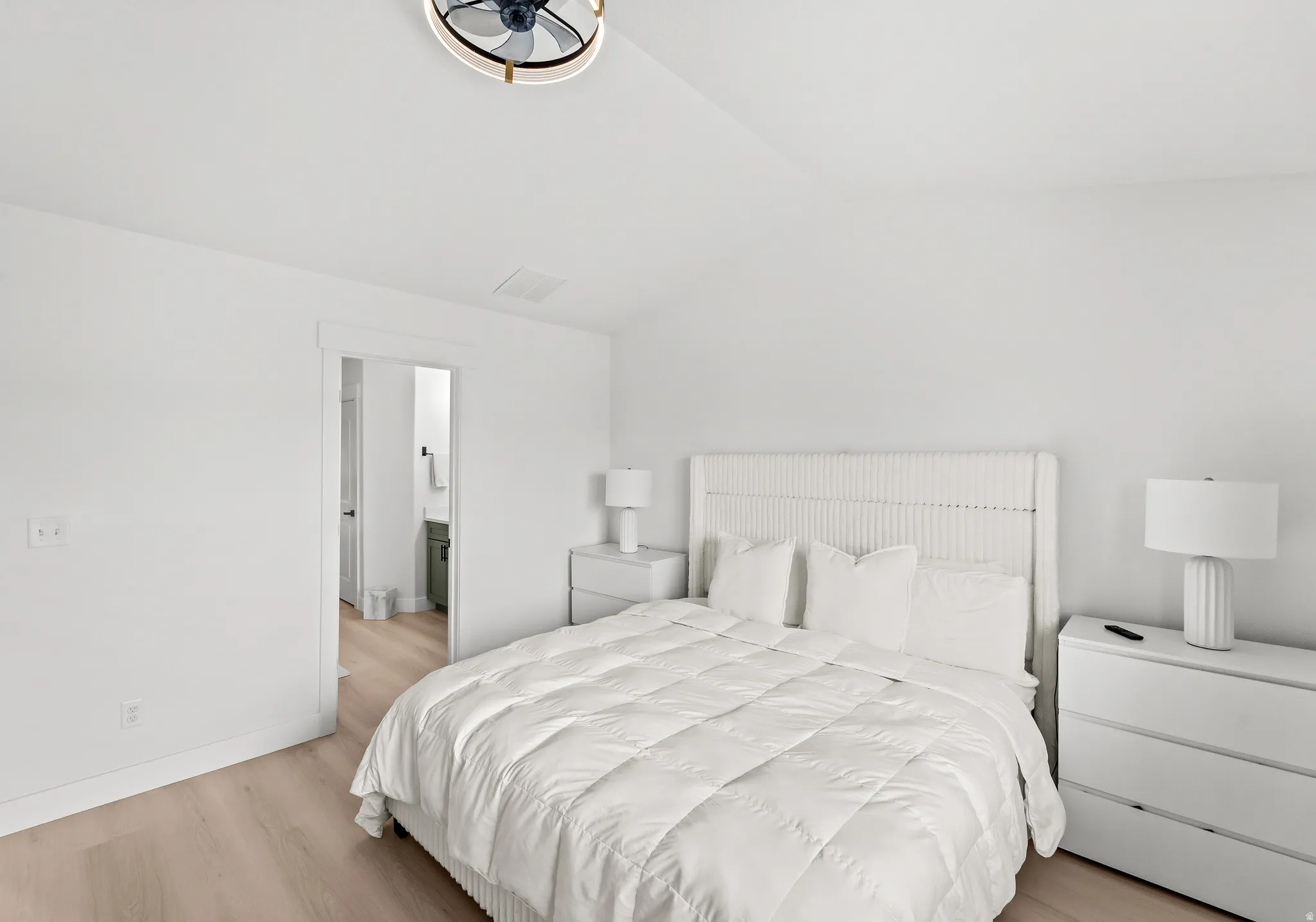 Light wood-finish flooring complements the crisp white walls