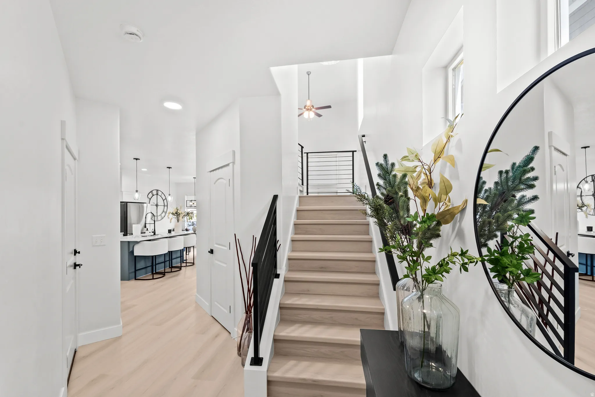Staircase with light wood-finish treads and black metal railings
