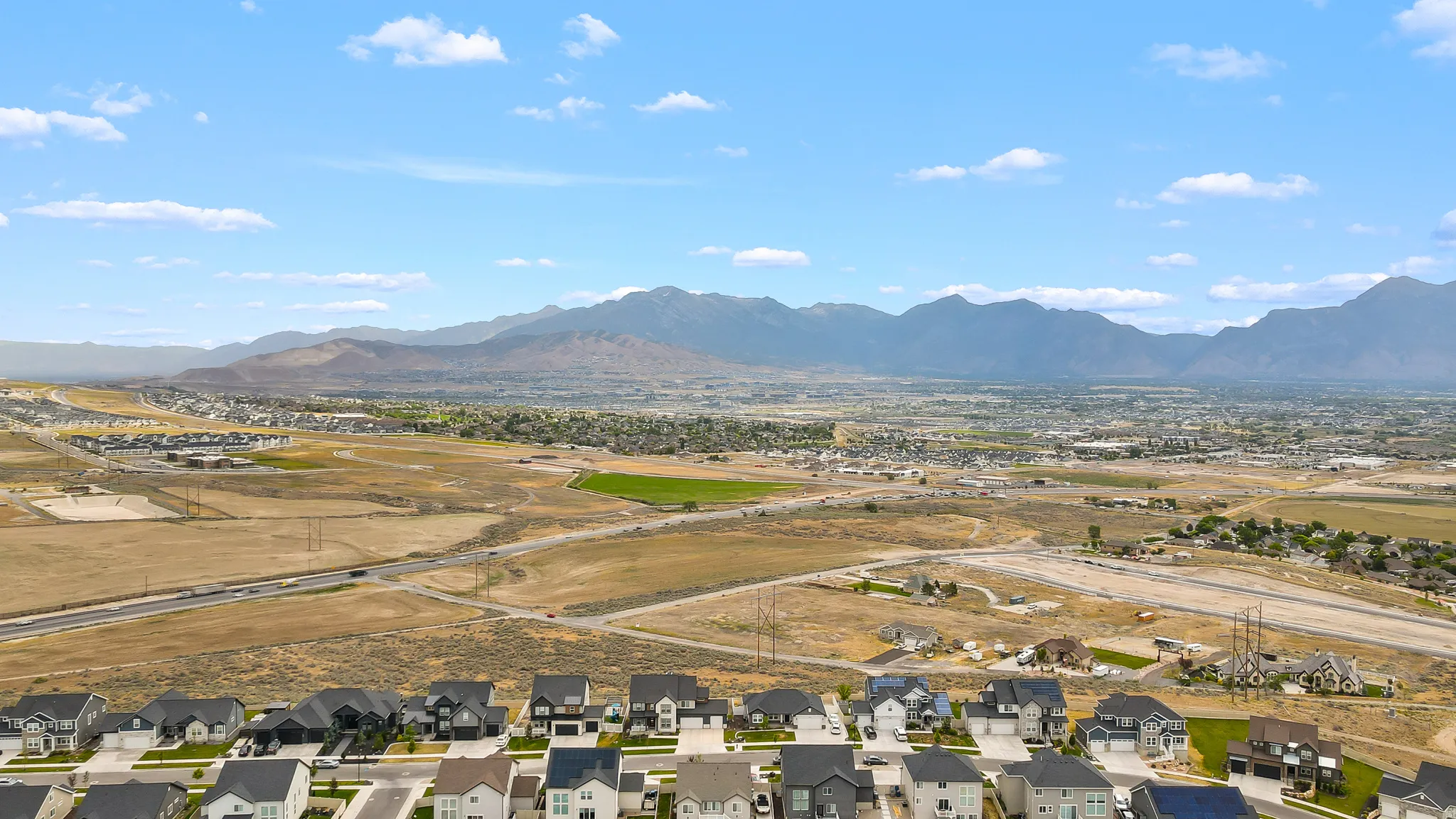 Expansive mountain range backdrop for a developing residential neighborhood