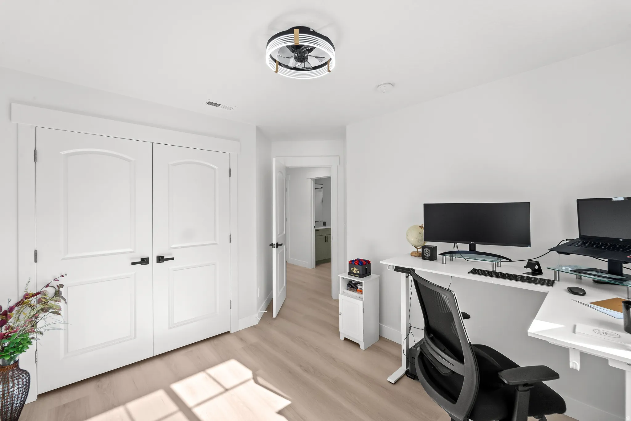 Bright interior room featuring light wood-finish flooring