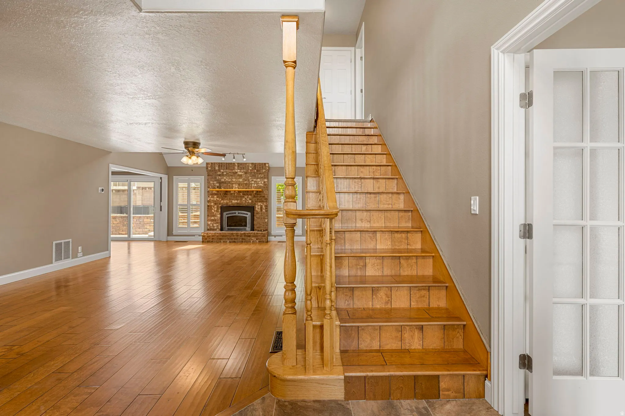 Staircase with wood balusters and tiled risers