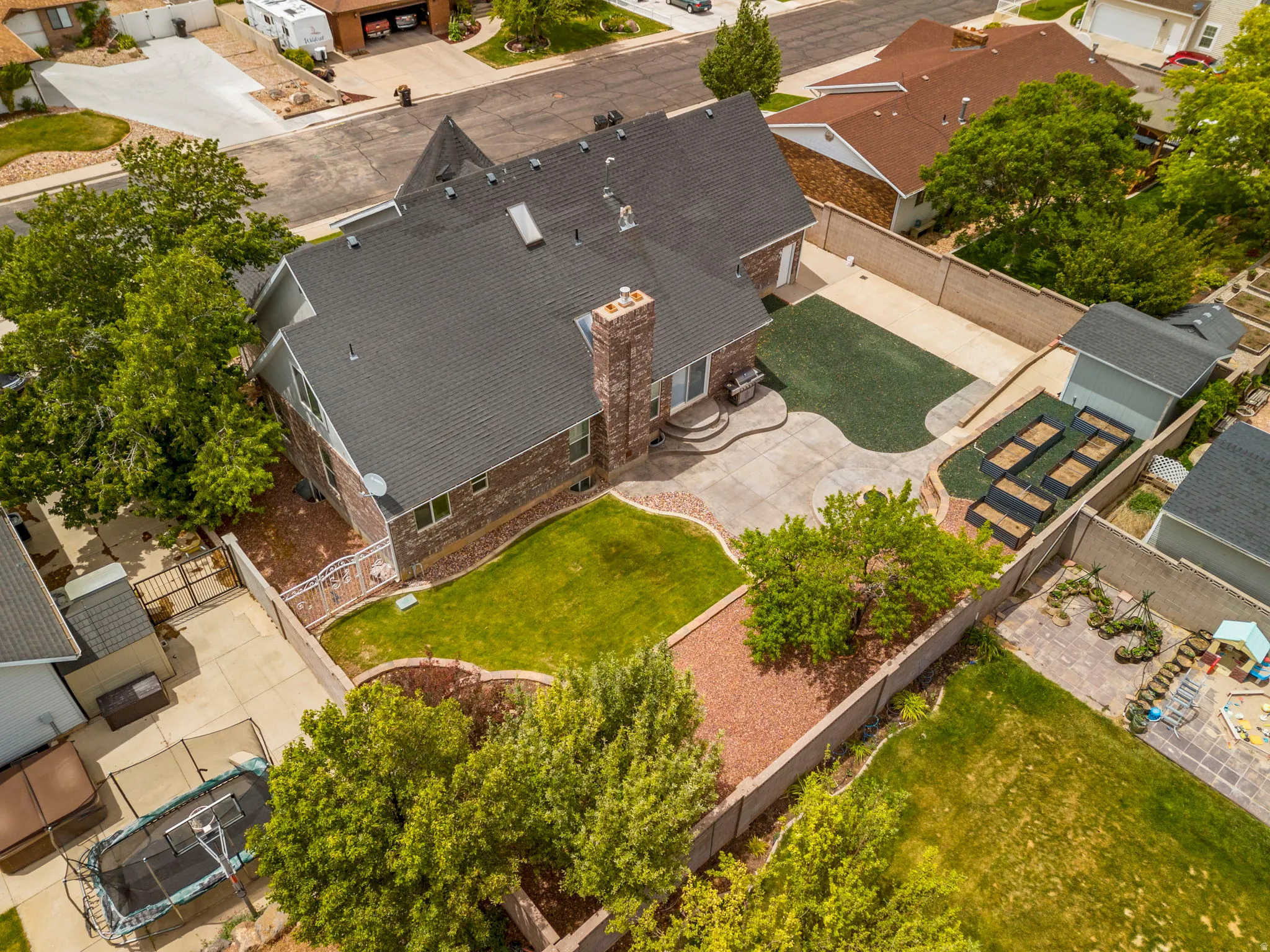 Brick exterior residence with a dark shingle roof