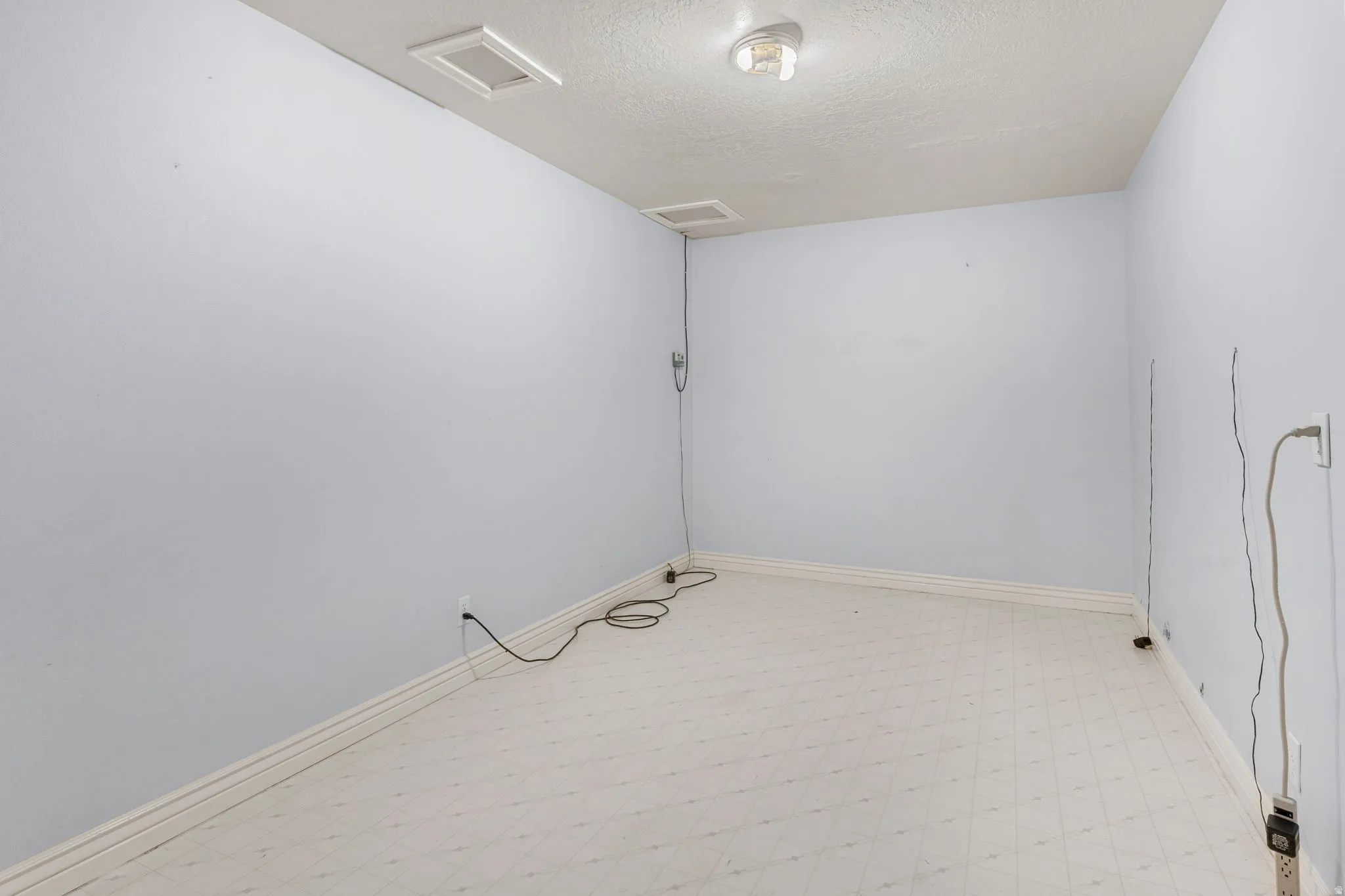 Room featuring light blue walls, white trim, and light-colored flooring