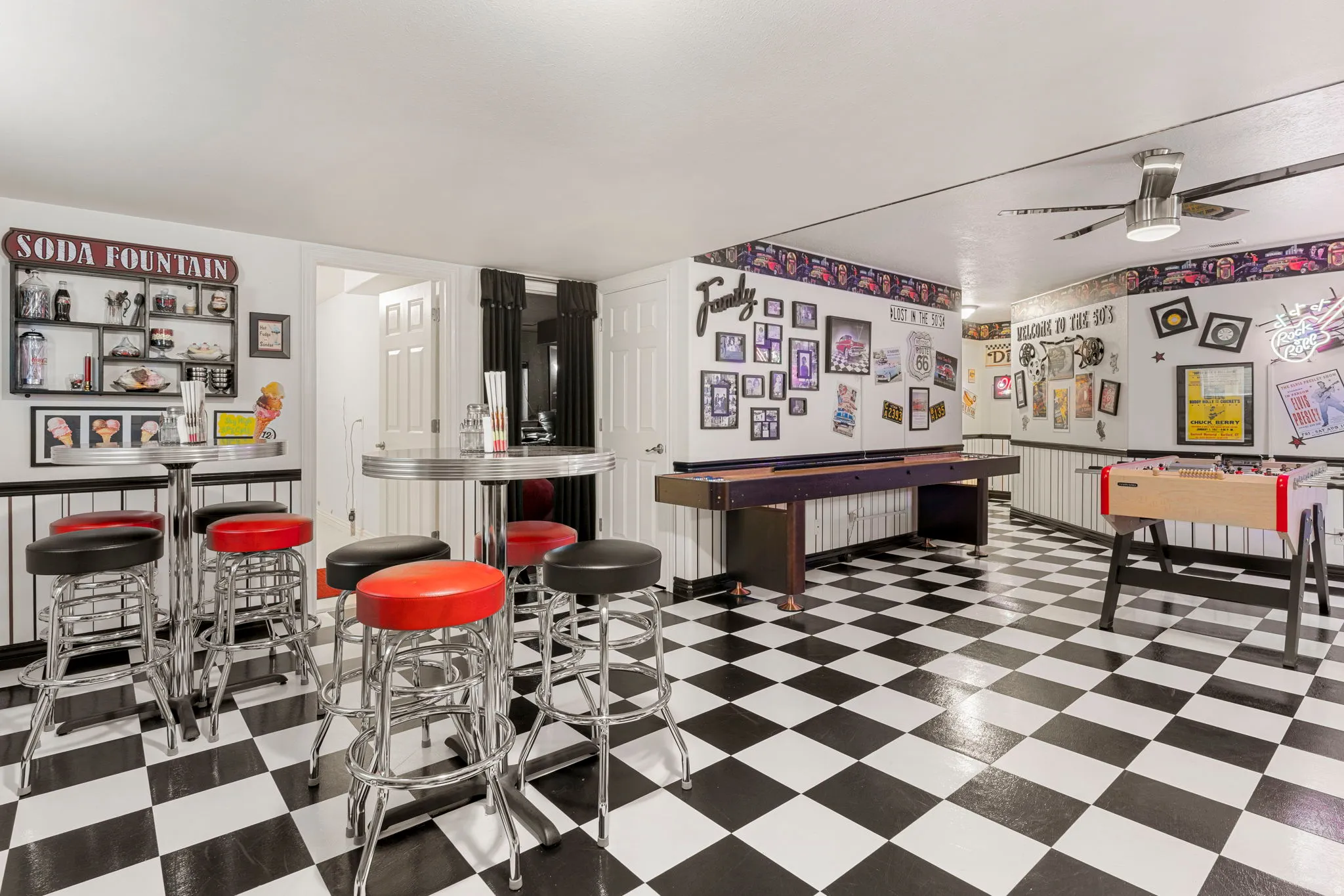 Entertainment space featuring checkerboard flooring, a built-in soda fountain, and a ceiling fan