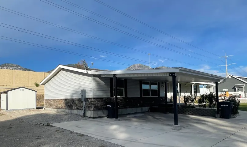 Vinyl siding exterior with a stone veneer foundation