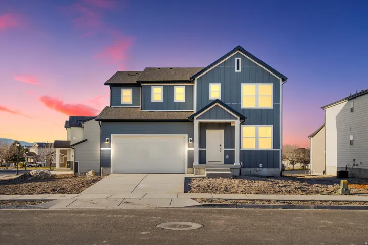 Modern two-story home featuring dark blue vertical and horizontal siding