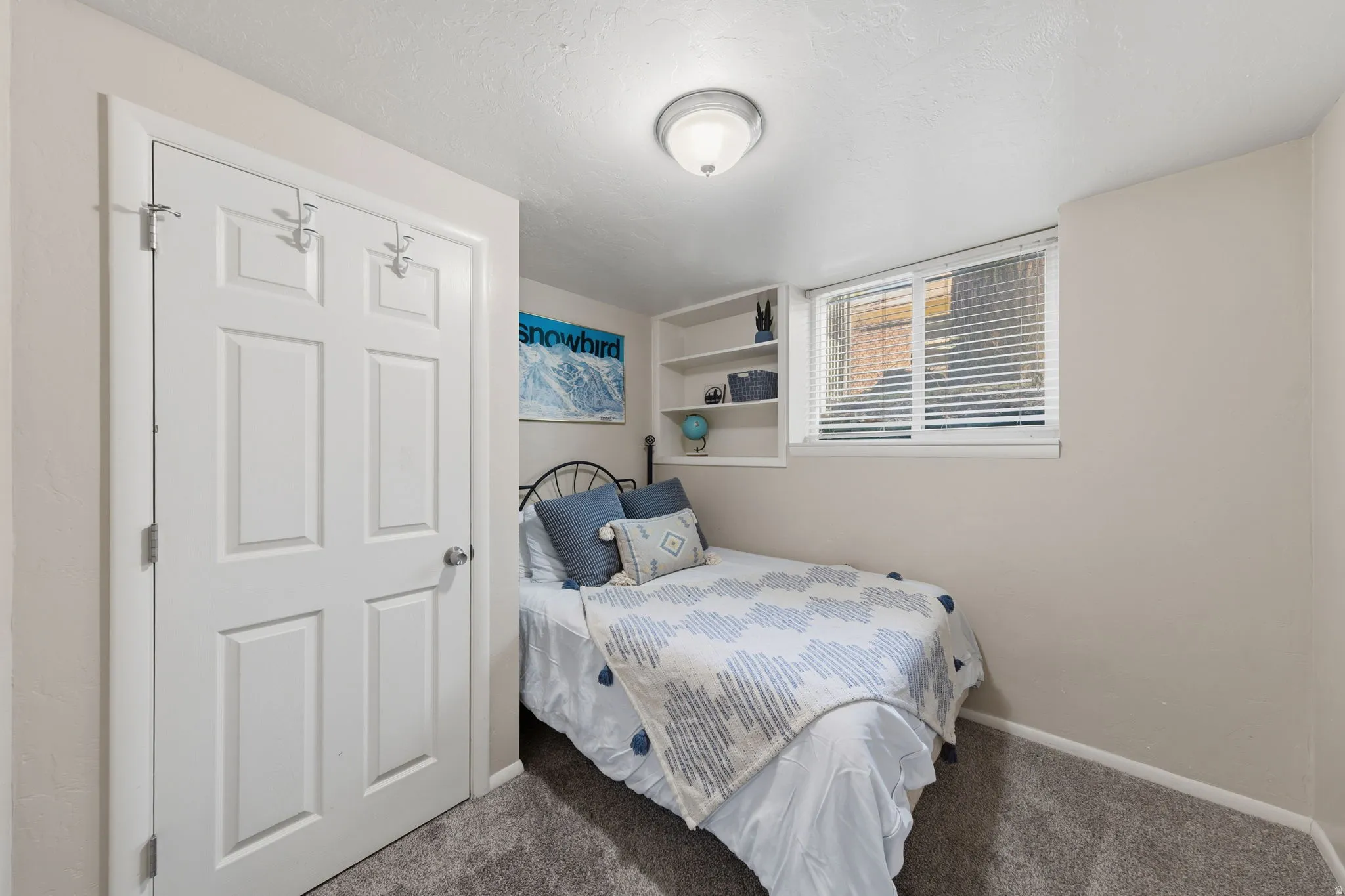 Bedroom featuring neutral-toned walls and plush gray carpeting