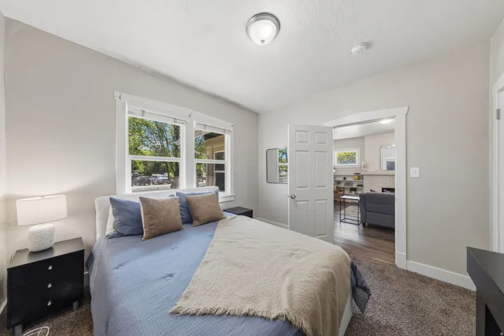 Carpeted room with light neutral wall paint, white trim, and a ceiling-mounted light fixture