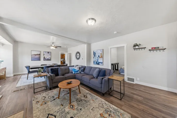 Open-concept living area featuring wood-finish flooring, light gray wall paint, and white trim