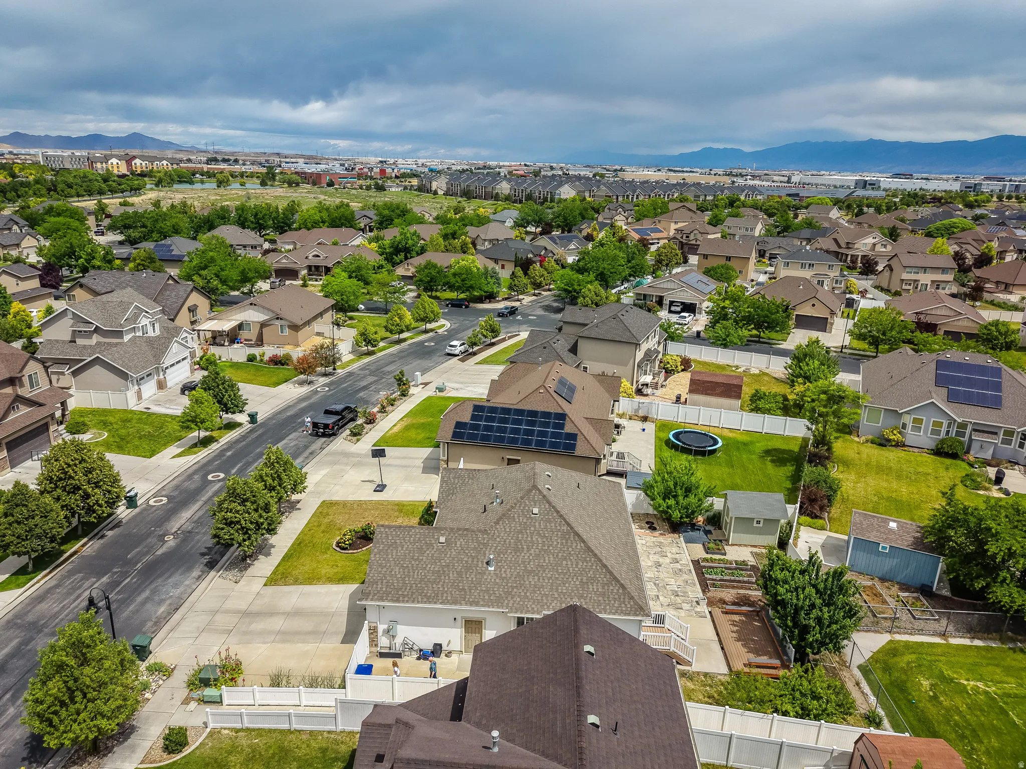Aerial perspective of a residential neighborhood featuring established homes with varying rooflines and mature landscaping