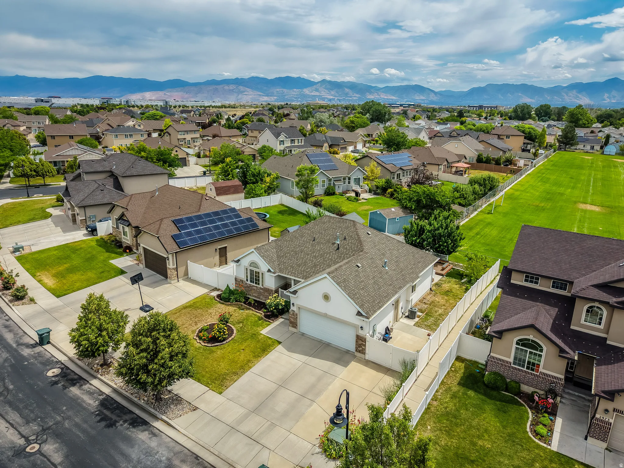 Residential community featuring a mix of architectural styles, paved roadways, and green spaces