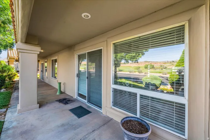 Concrete patio with stucco columns, recessed lighting, and a sliding glass door