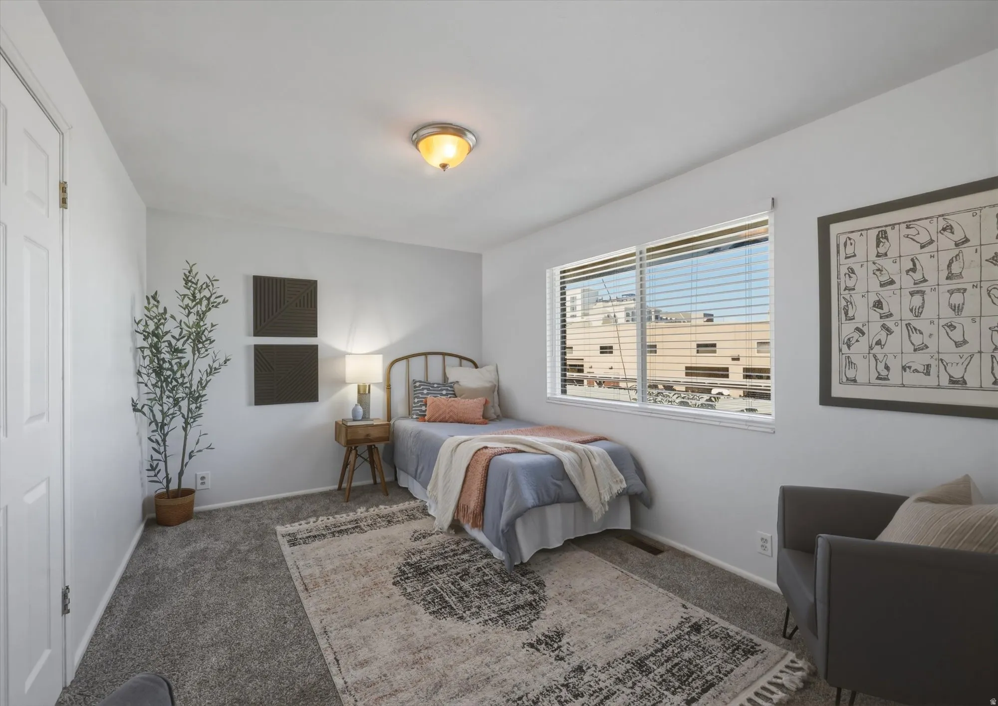 White paneled door, gray carpet flooring, white walls, and a large window with white blinds