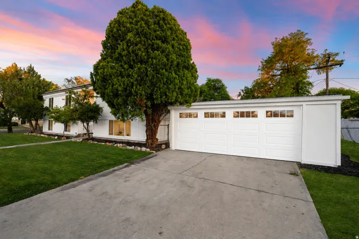 White exterior with a two-car garage featuring square window inserts