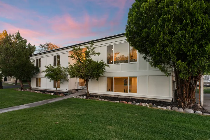 Two-story residential structure featuring a white exterior with black trim