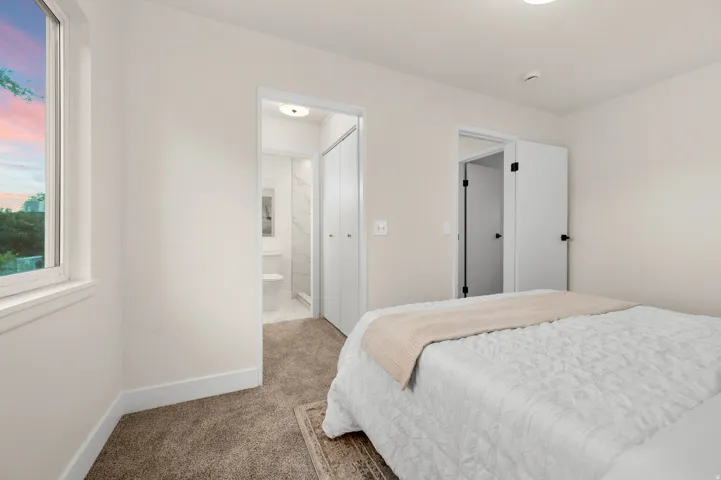 Carpeted room with a double-pane window and white trim