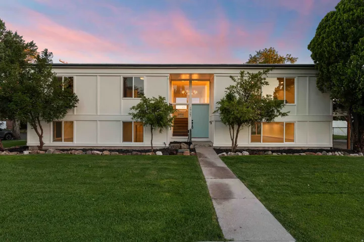 Contemporary two-story exterior with a clean white facade and contrasting dark trim