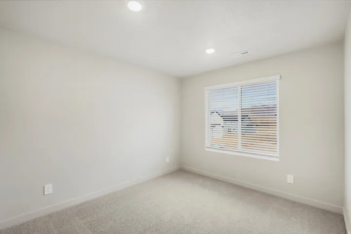 **DISCLAIMER** Interior package may vary. Neutral-toned interior with recessed ceiling lighting, light gray wall paint, and gray carpeting