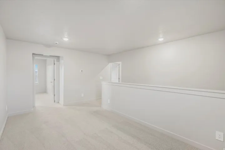 **DISCLAIMER** Interior package may vary. Carpeted loft area with recessed lighting, light gray walls, and white trim