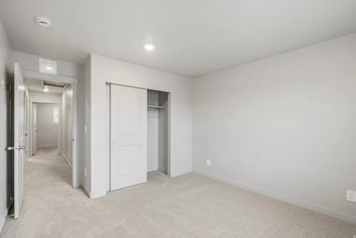 **DISCLAIMER** Interior package may vary. Carpeted room with light grey walls and white trim