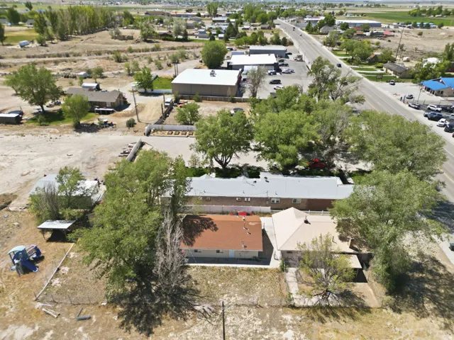 Aerial perspective showcasing multiple structures and expansive surrounding land
