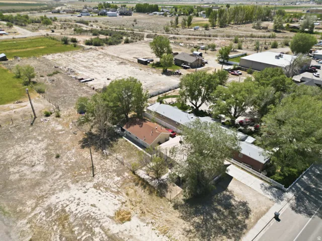 Aerial property overview featuring multiple structures and expansive land
