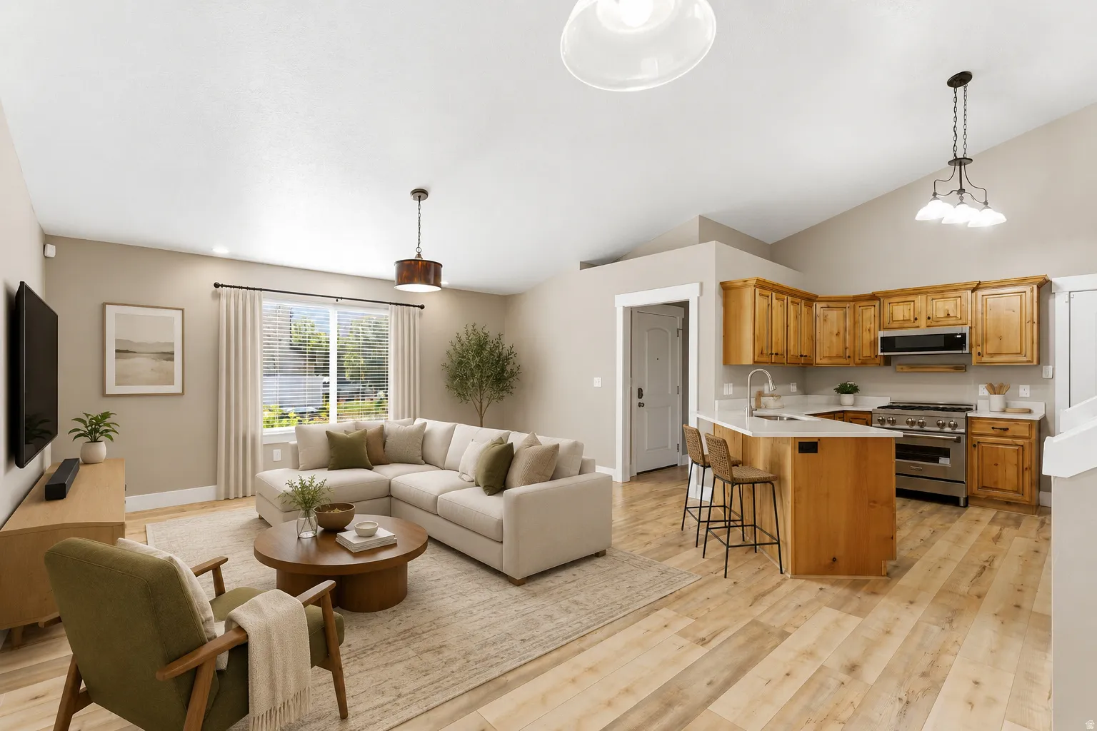 Virtually staged photo. Open-concept living space featuring vaulted ceilings, new LVP flooring, and natural wood cabinetry