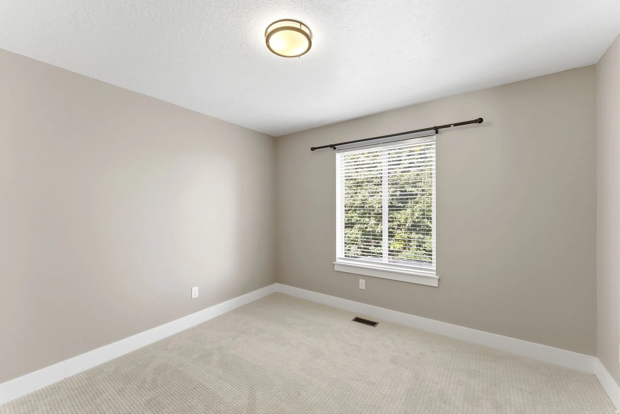 Bedroom 3, featuring neutral-toned walls, white trim, and new carpet flooring