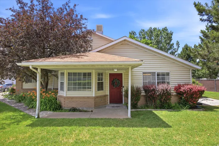 Traditional exterior with light-colored siding and a contrasting red entry door