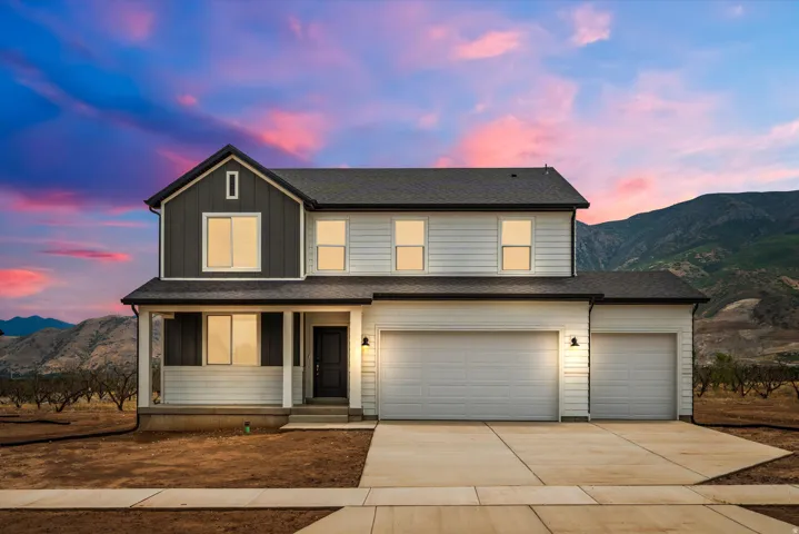 Two-story residence featuring a dark gray gable facade and white horizontal siding