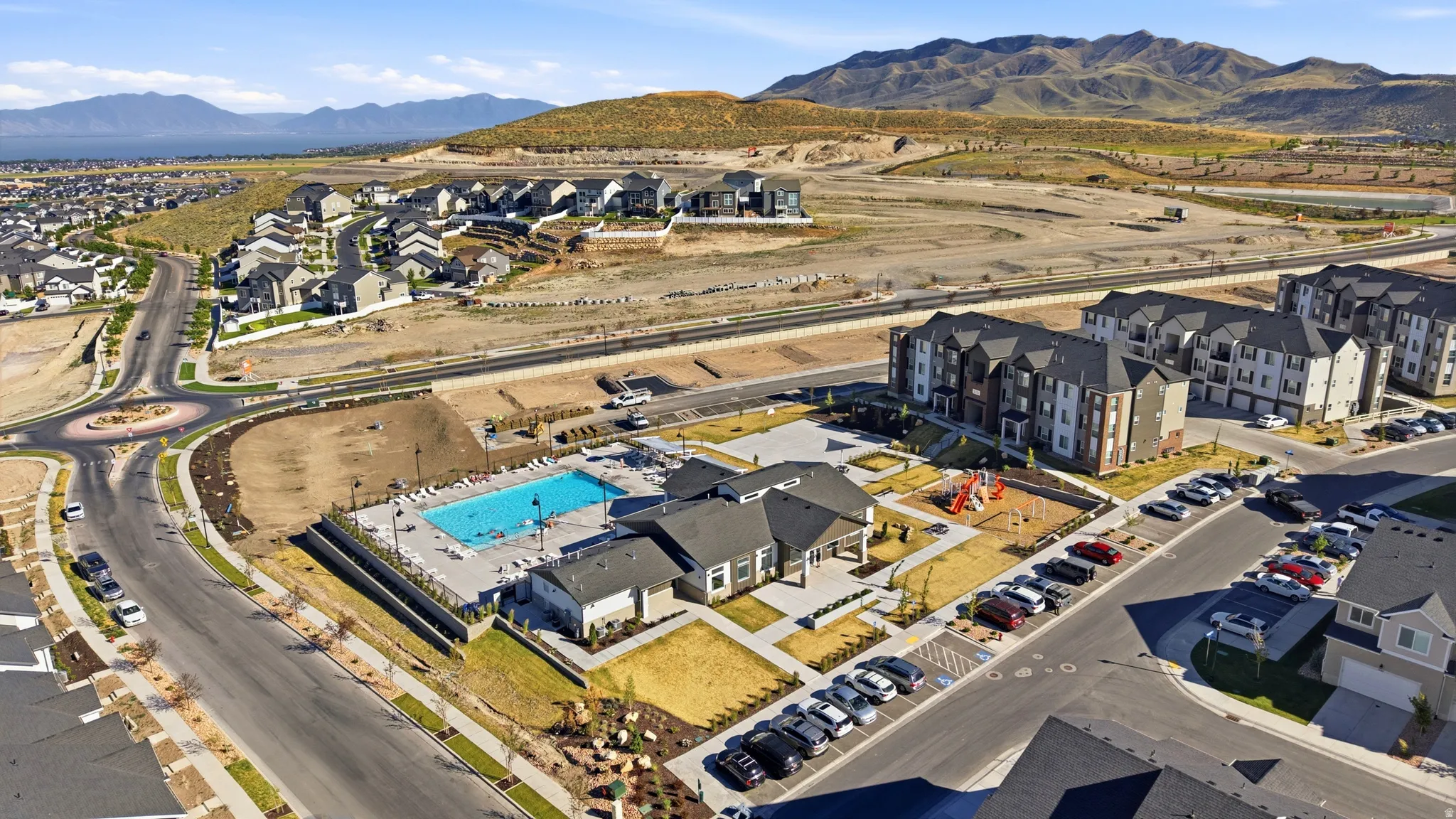 Community amenities featuring an outdoor swimming pool, integrated clubhouse, and dedicated playground area