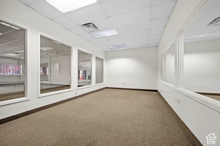 Spacious interior featuring neutral carpeting and white painted walls