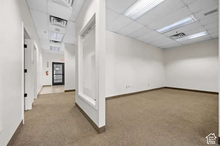 Carpeted office space featuring recessed lighting and a drop ceiling