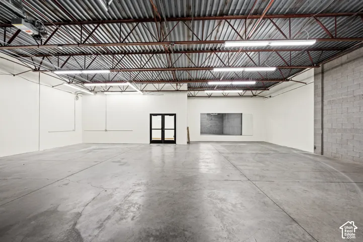Spacious open-concept interior featuring a concrete floor and white walls