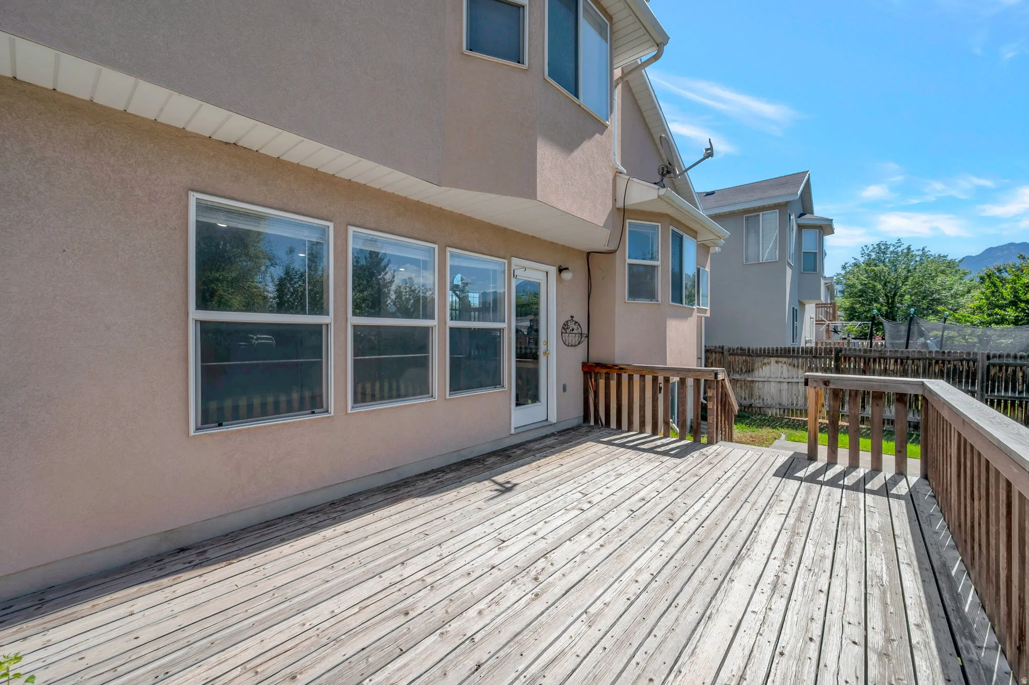 Spacious outdoor wood-finish deck with wooden railing