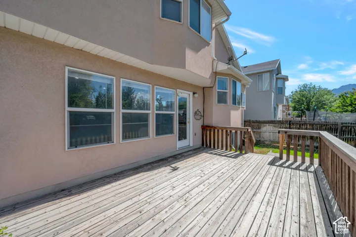 Spacious outdoor wood-finish deck with wooden railing