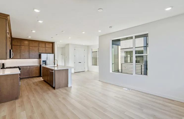 Kitchen and living area featuring light wood-finish flooring