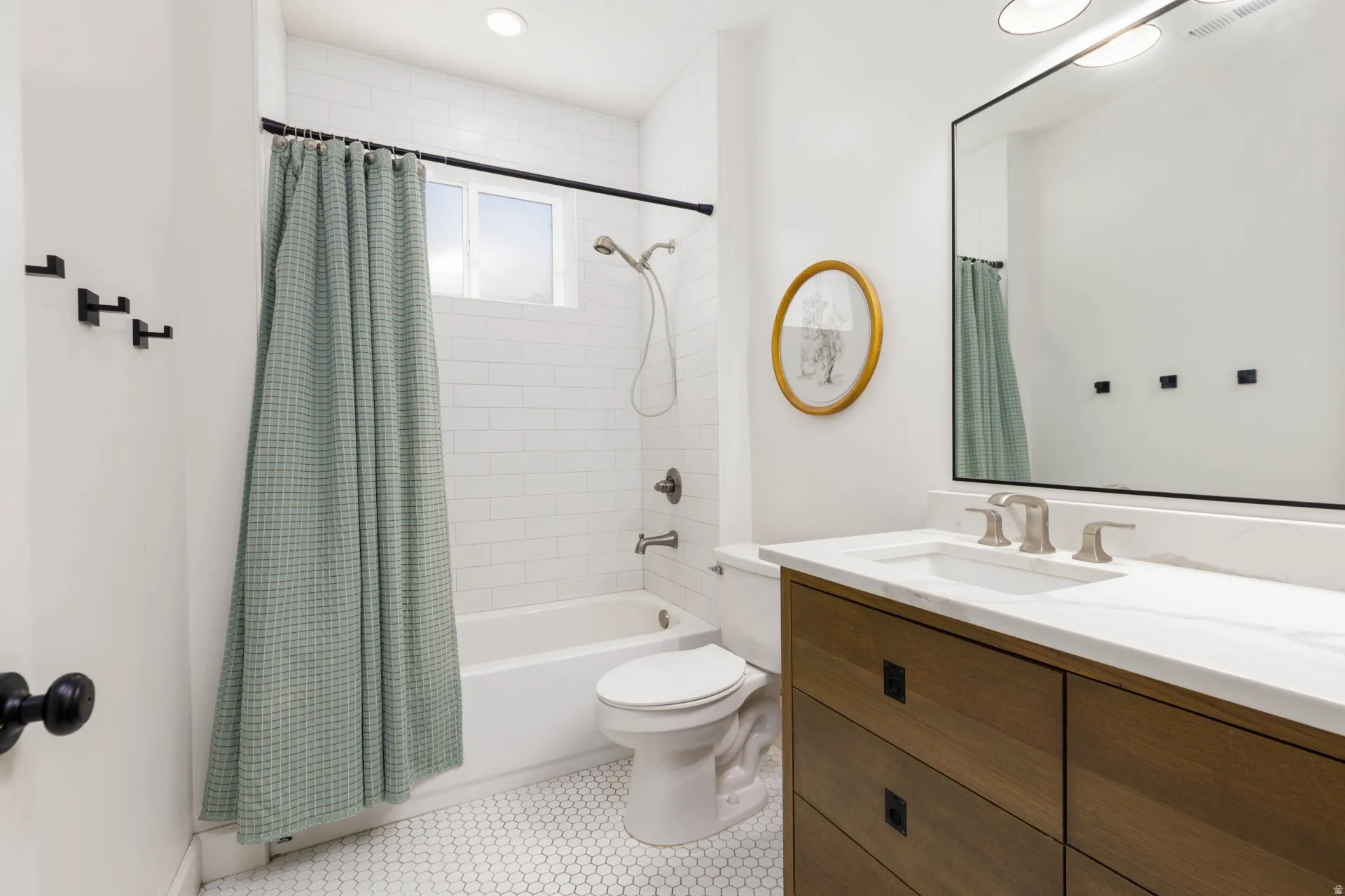 Bathroom featuring a wood-finish vanity with a white countertop and integrated rectangular sink