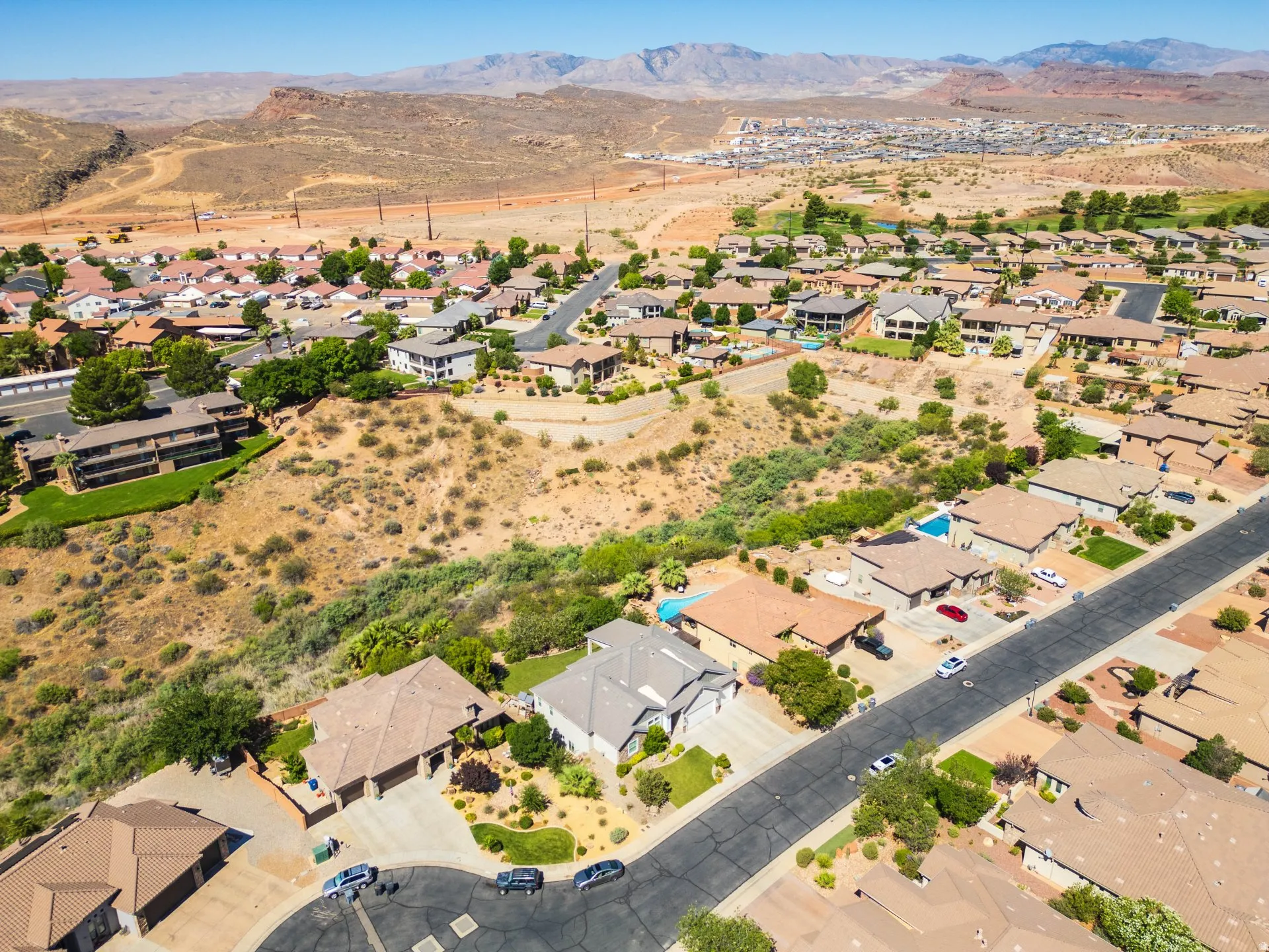 Residential neighborhood with varied rooflines and a mix of paved driveways and desert landscaping