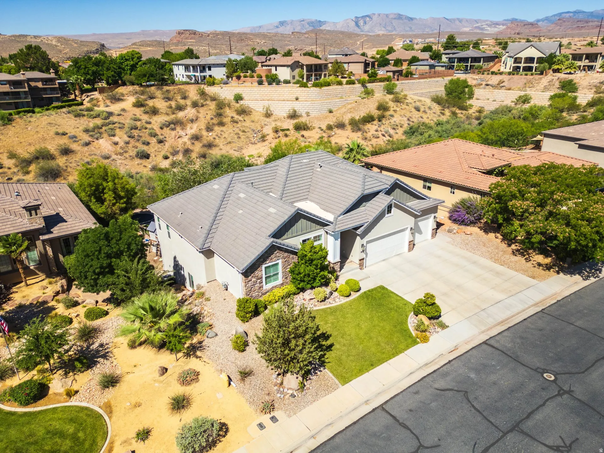 Single-story residence featuring a tile roof, stucco exterior, and stone accents