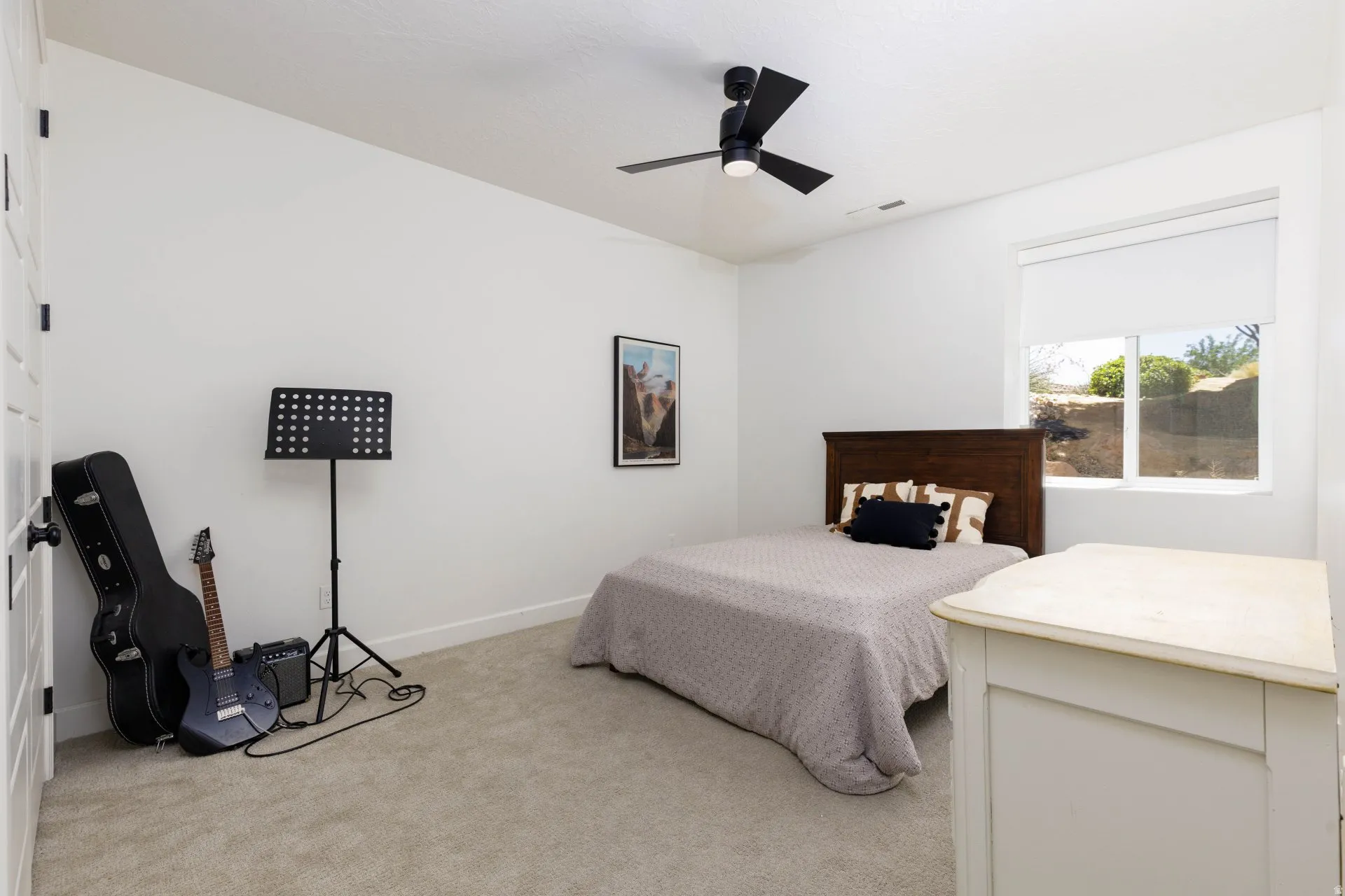 Neutral-toned carpeting complements the white walls