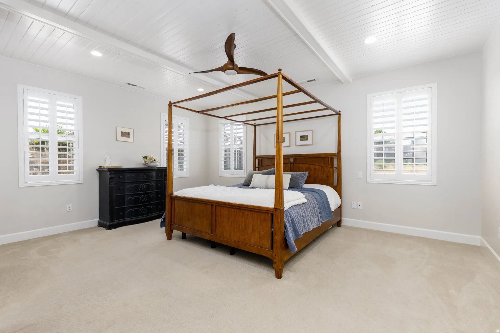 Spacious room featuring a white paneled ceiling with recessed lighting and a ceiling fan