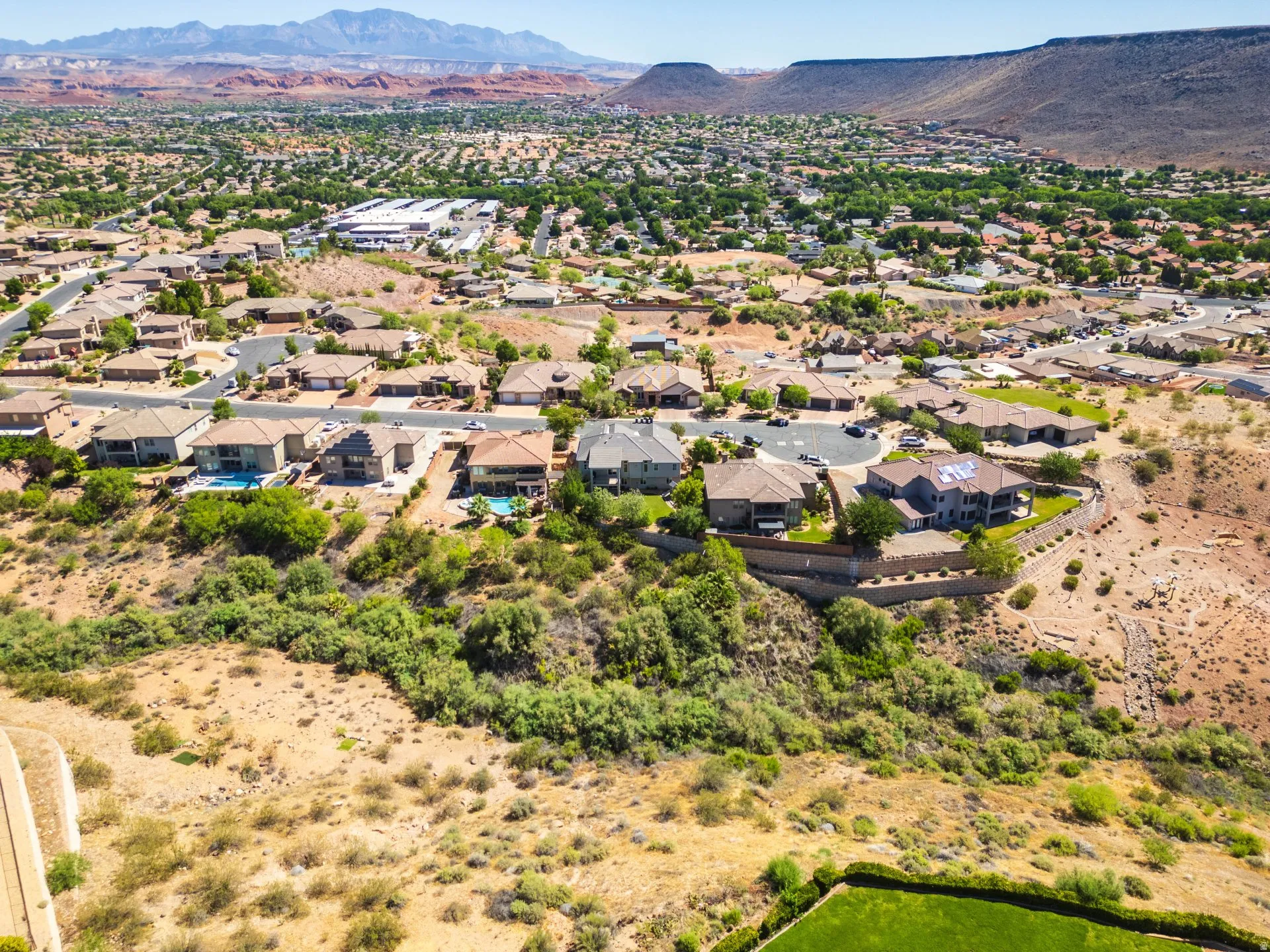 Expansive aerial view showcasing a residential community nestled among natural desert landscape