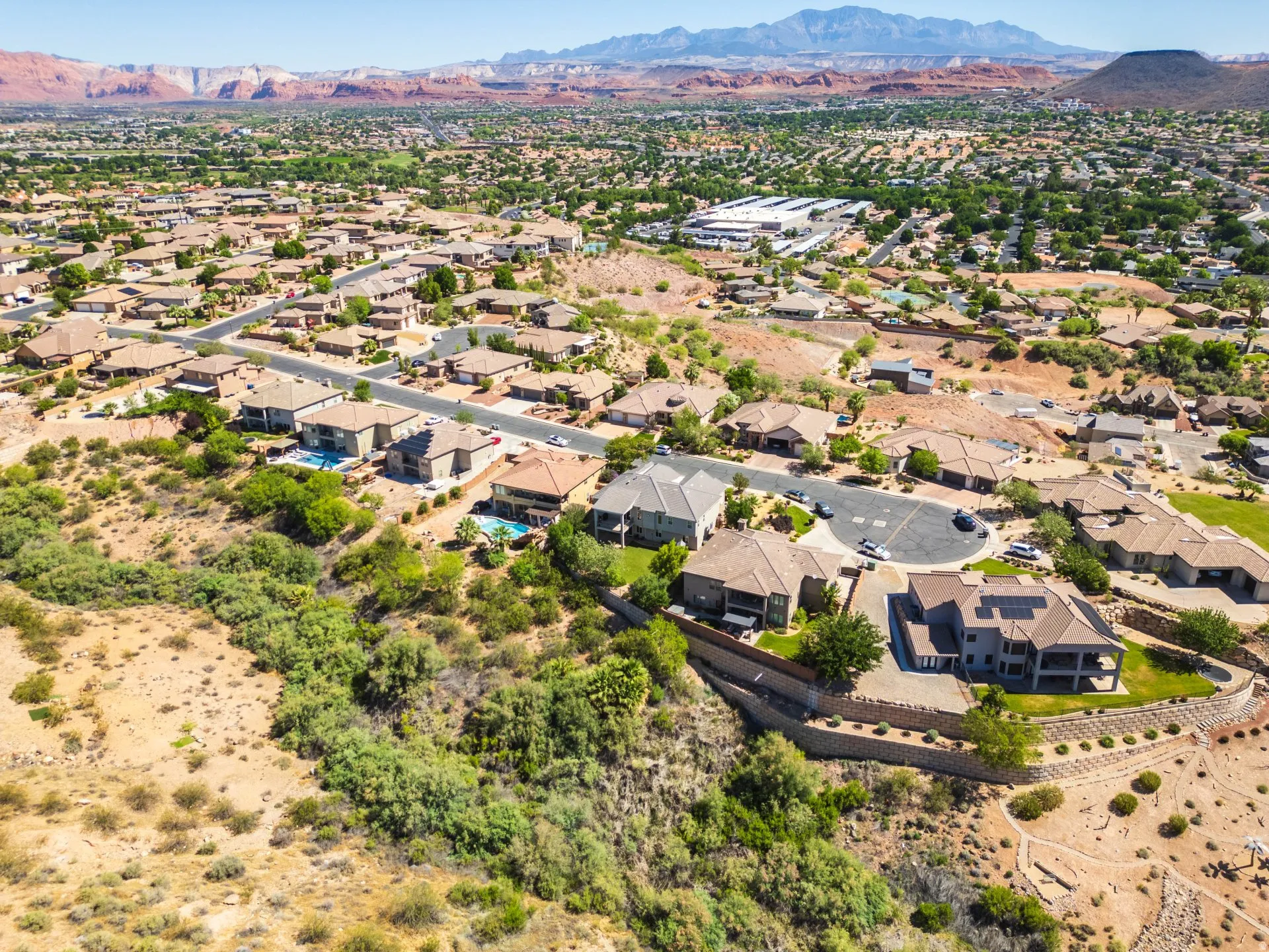 Residential neighborhood featuring various architectural styles, paved roadways, and mature landscaping