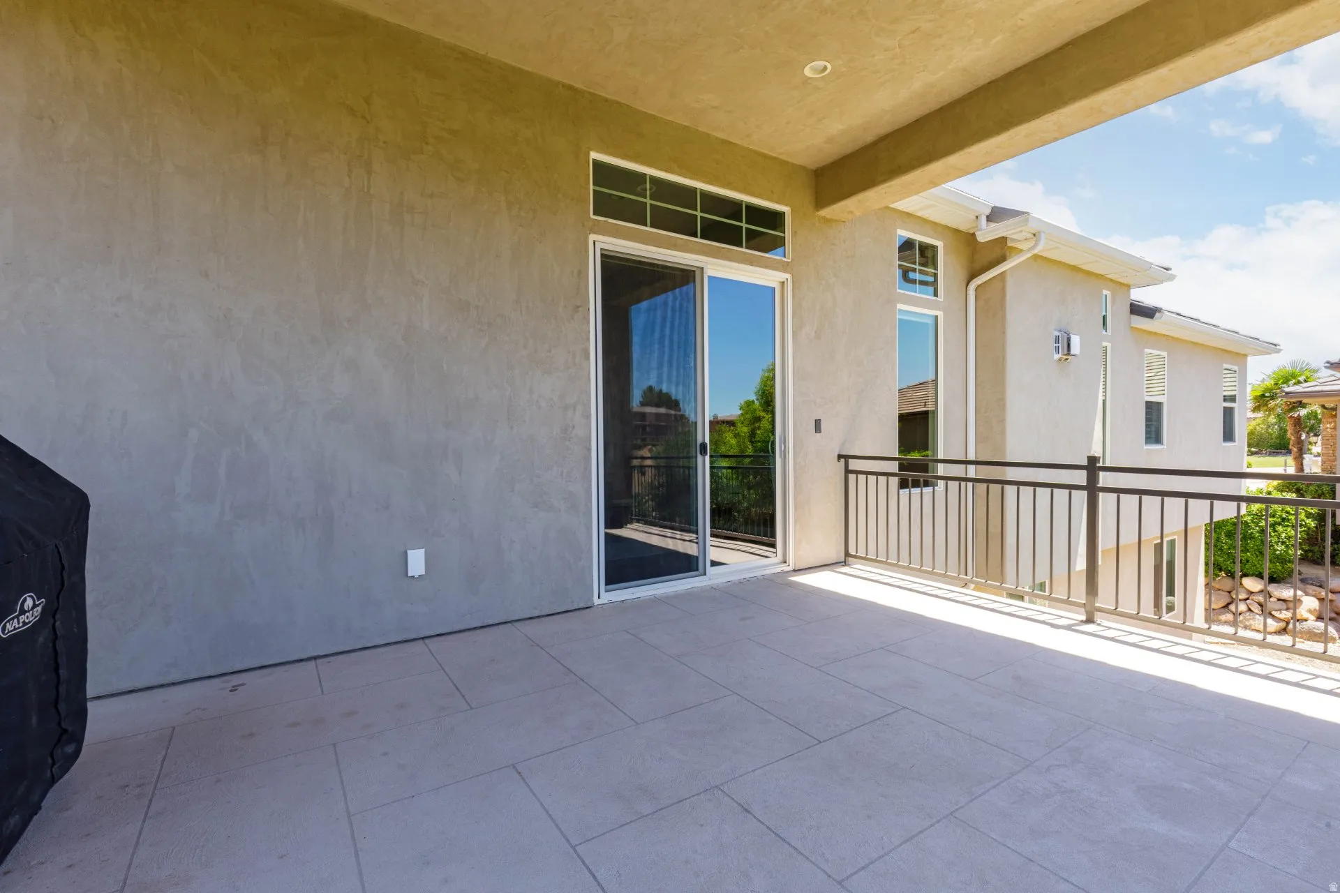 Outdoor patio featuring light-toned tile flooring and a covered ceiling