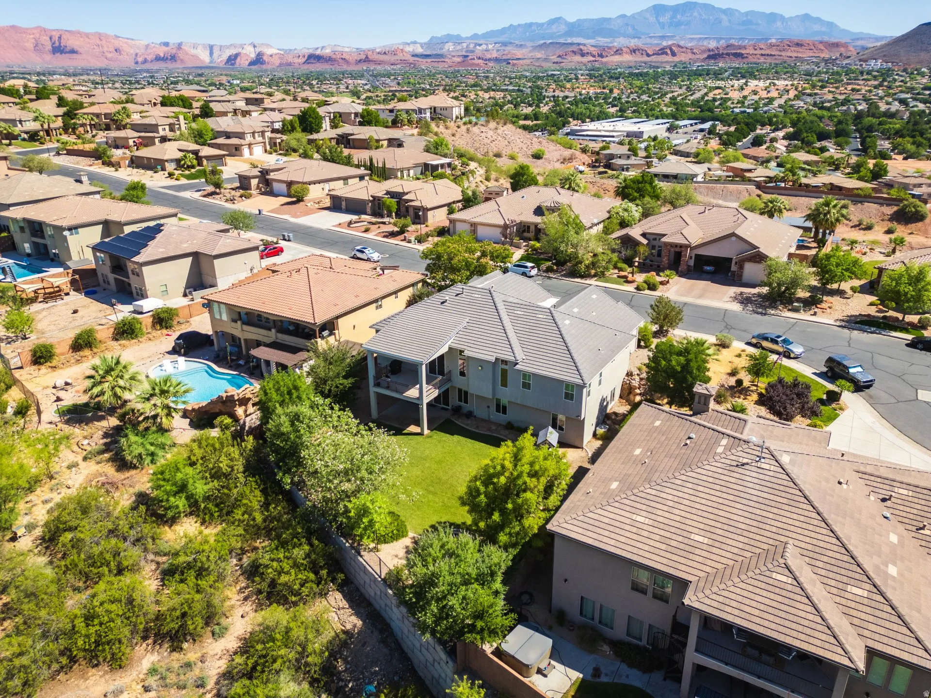 Expansive residential property featuring a multi-story dwelling with a tiled roof and a large backyard area