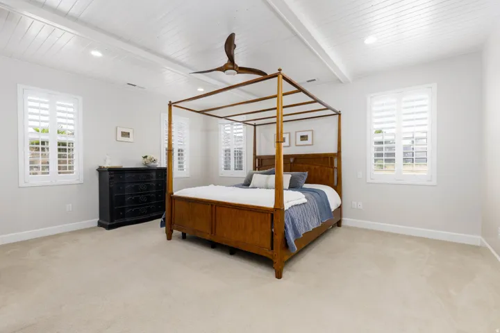 Spacious room featuring a white paneled ceiling with recessed lighting and a ceiling fan