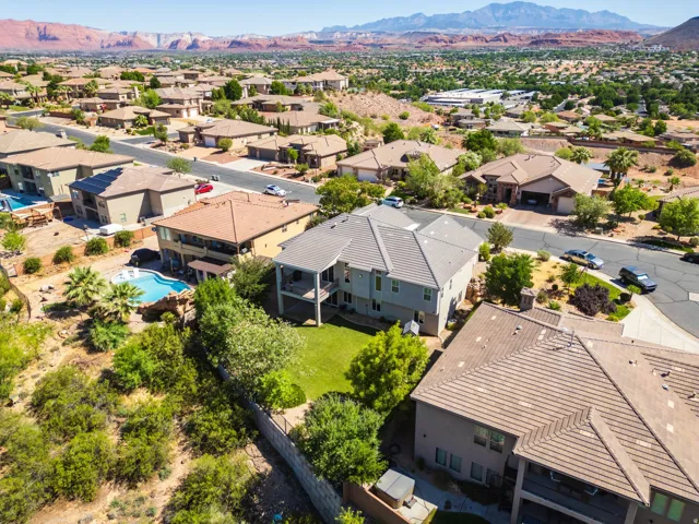 Expansive residential property featuring a multi-story dwelling with a tiled roof and a large backyard area