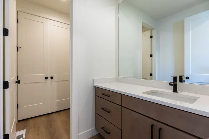 Wood-finish vanity with a white countertop and integrated rectangular sink