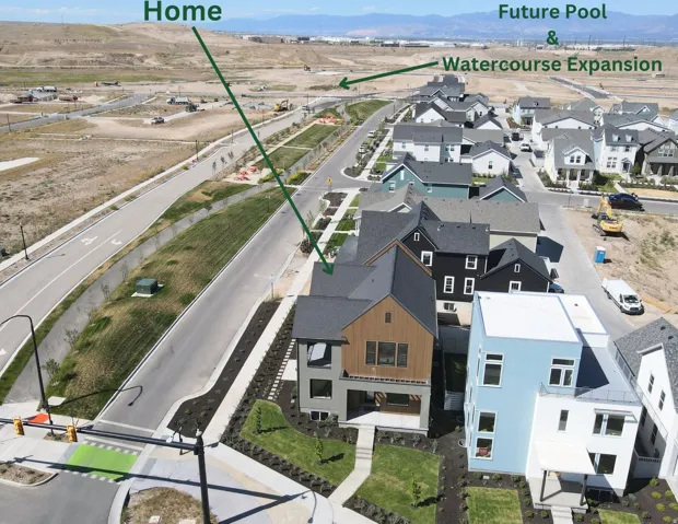 Modern residential development featuring a variety of architectural styles, paved streets, and landscaped front yards